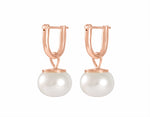 White button pearls in 18k rose gold drops on hoops.