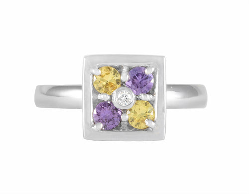 Platinum ring with purple and yellow sapphires and a diamond.